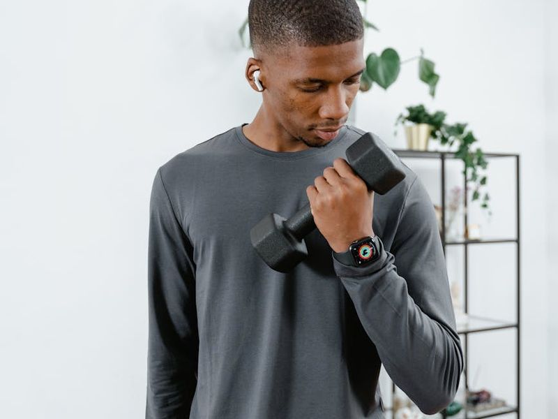 A man focused during a static strength hold exercise.